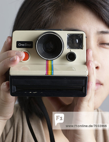 Close-Up of Woman Using Instant Camera