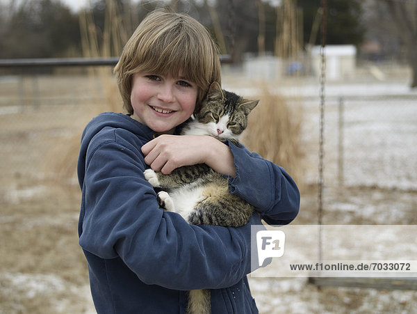 Portrait of Boy Holding Cat