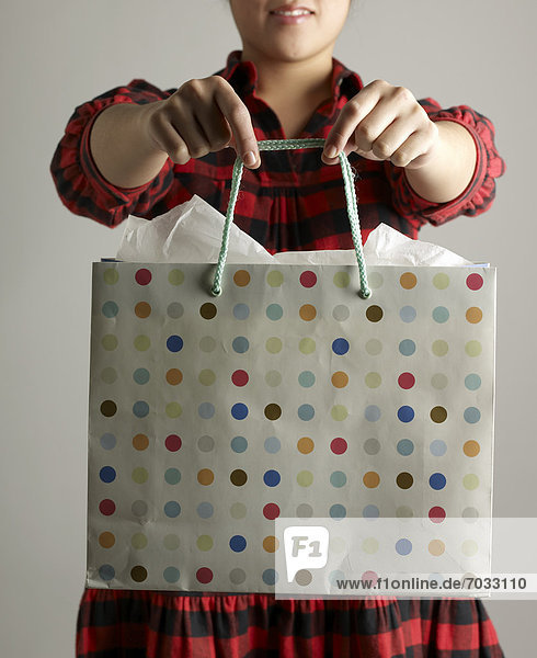 Mid-Adult Woman Holding Shopping Bag