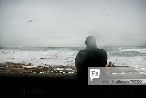 Person Looking Out At Stormy Sea