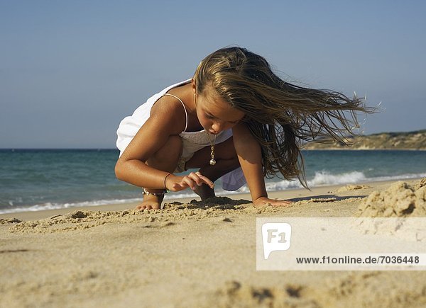 Young Girl Playing On Beach