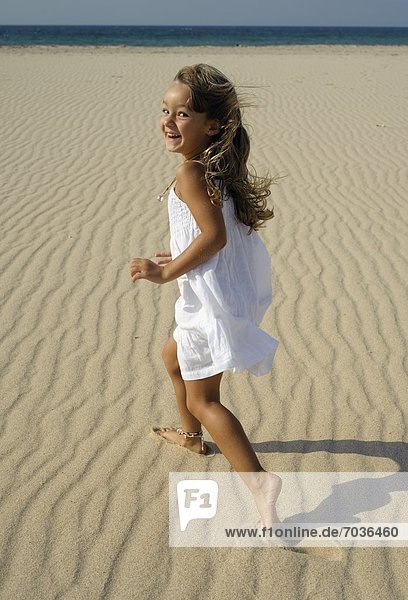 Young Girl Running On Beach