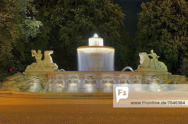 Wittelsbach Fountain at night  monument  built between 1893 and 1895 after plans by sculptor Adolf von Hildebrand in classical style  allegory on the elementary power of water  Lenbachplatz square  Munich  Bavaria  Germany  Europe  PublicGround