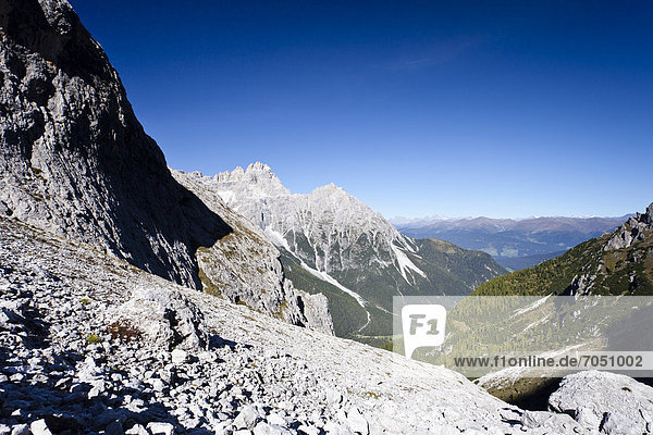 Hiker during the ascent to Alpinisteig Mountain through the Fischlein Valley above the Talschlusshuette hut  with Dreischusterspitze Mountain at the rear  Dolomites  Alta Pusteria  Sexten  Alto Adige  Italy  Europe