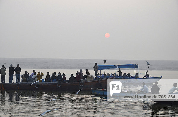 Believers in boats on the Ganges river at sunrise  Varanasi  Benares or Kashi  Varanasi  Uttar Pradesh  India  Asia