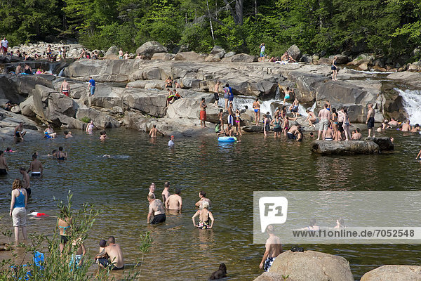 Swimmers on a hot summer afternoon at the lower falls of the Swift River in White Mountain National Forest  Conway  New Hampshire  USA