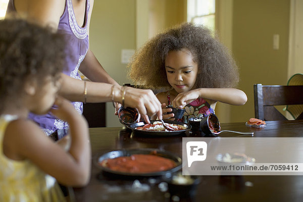 Mixed race girls eating dinner