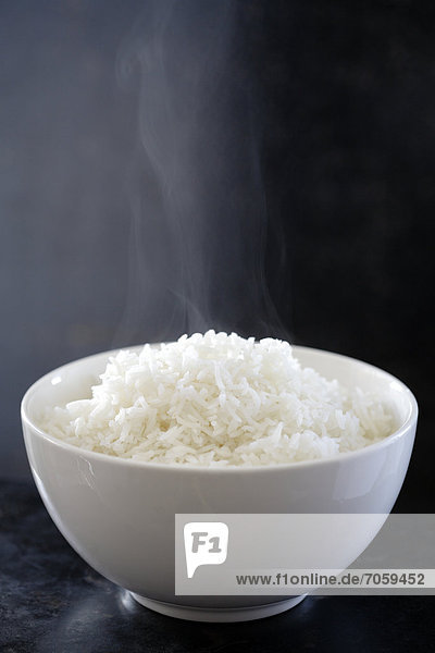 Steaming bowl of cooked rice