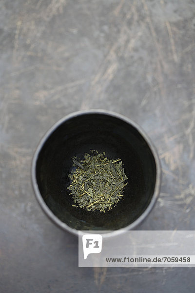 Dried sencha tea in tea cup