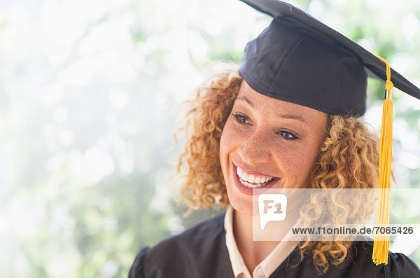 Portrait of smiling young woman in mortarboard
