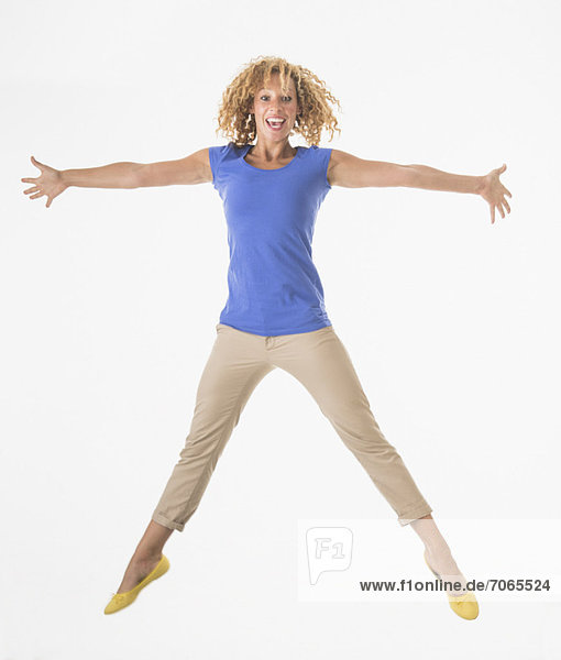 Woman jumping  studio shot