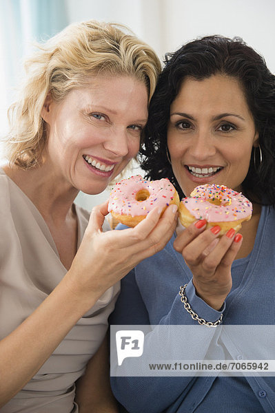 Female friends eating donuts
