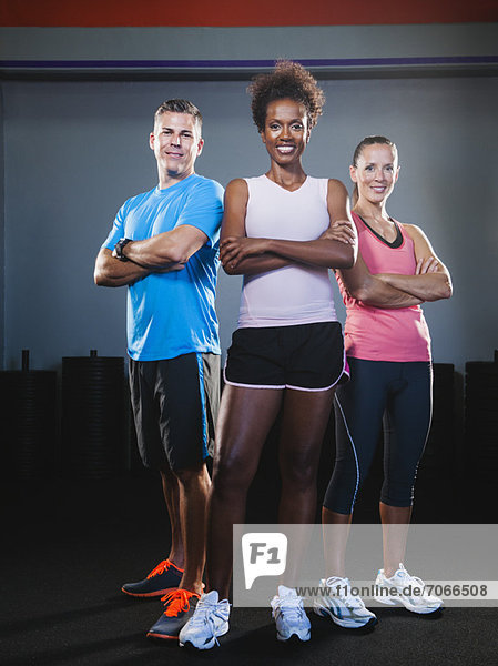 Portrait of three people in gym
