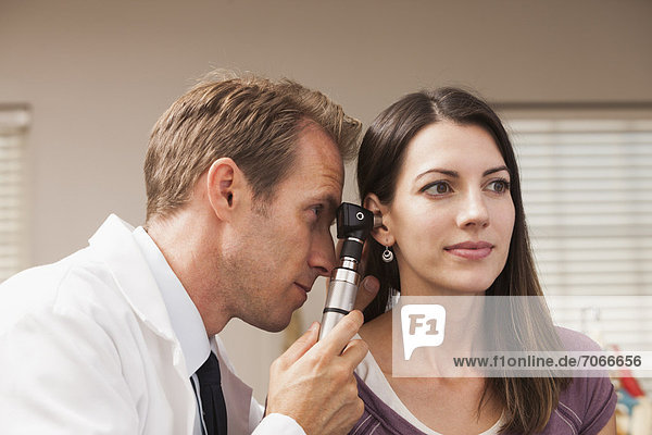 Doctor performing hearing test with Otoscope