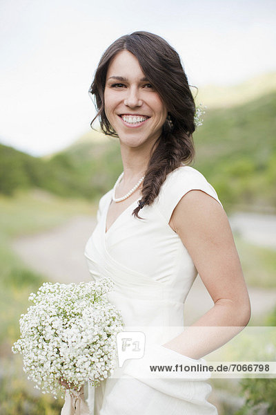 Portrait of smiling woman in white dress