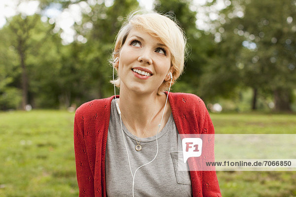 Portrait of smiling woman listening to music