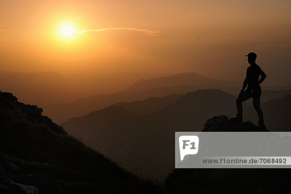 Sunset with a silhouette of a mountain climber  Geisshorn Mountain  Tannheim Valley  Tyrol  Austria  Europe