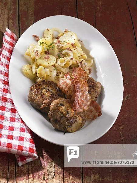Meat balls with mushrooms  bacon and potato salad