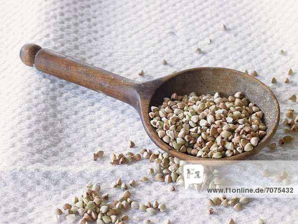Buckwheat on a wooden spoon