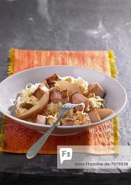 Sauerkraut salad with smoked pork and pears