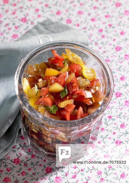 Sweet and sour vegetables in a glass with mango  pepper and aubergine