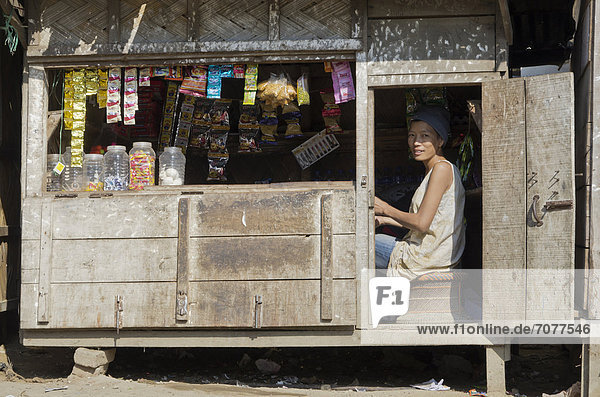 Woman selling goods in a wooden shack in the outskirts of Sibsagar  Sibsagarh  India  Asia