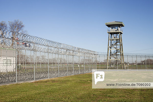 Prison fence  watch tower and barbed wire at Correctional Facility. High security.