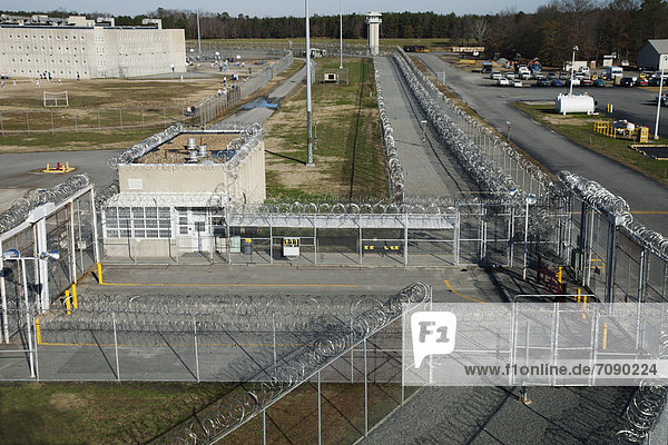 Elevated view of Prison grounds  Entrance Gate  and the vehicle lock  perimeter fence and watch tower at a Correctional Facility.