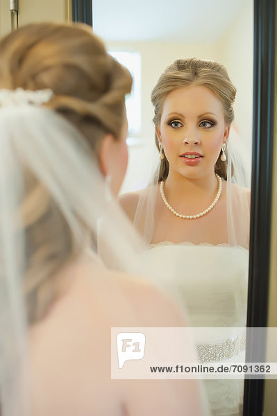 USA  Texas  Young bride looking into mirror  close up