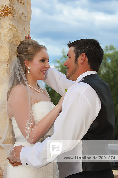 USA  Texas  Bride and groom romancing  close up