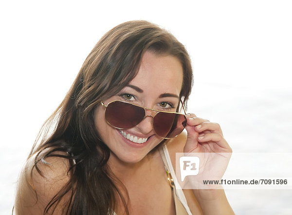 Young woman with sunglasses  smiling  portrait