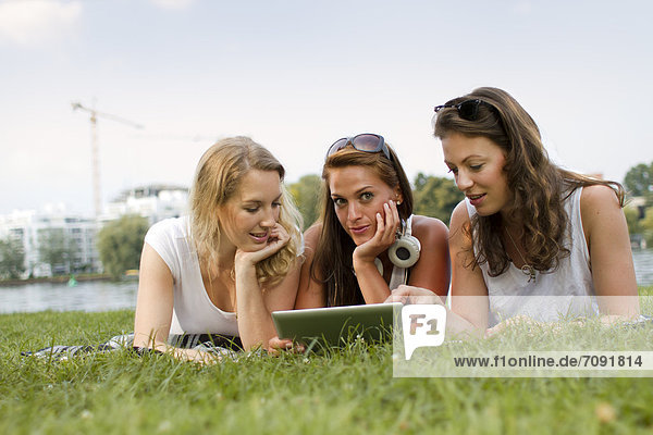 Germany Berlin Young students relaxing at Treptower Park