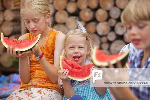 Germany  Bavaria  Group of children eating watermelon