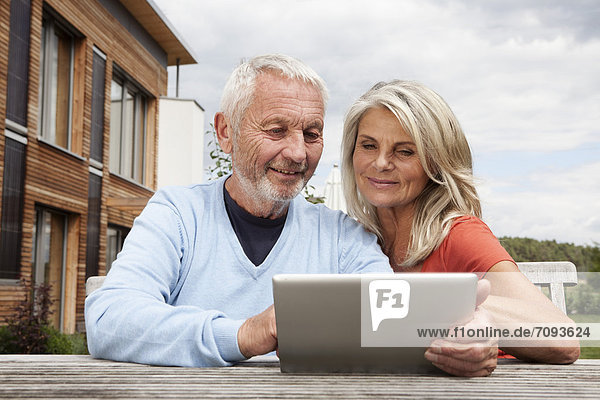 Germany  Bavaria  Nuremberg  Senior couple using digital tablet