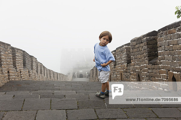 Boy looking over shoulder  Great Wall  China