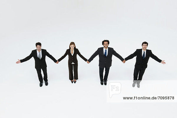 Business associates holding hands  elevated view