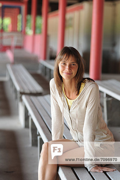 Smiling woman sitting on bench
