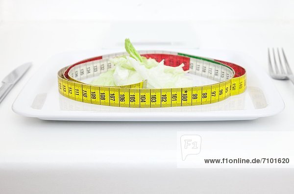 Plate with salad and tape measure