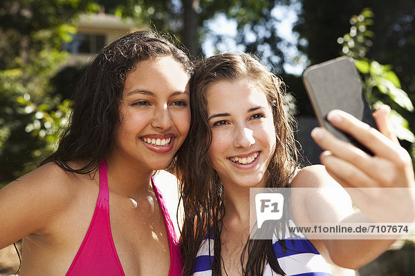 Friends taking self-portrait with cell phone