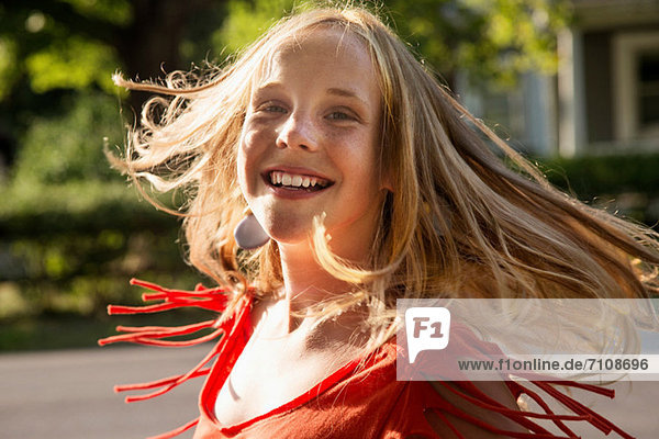 Close up portrait of blonde girl looking at camera smiling