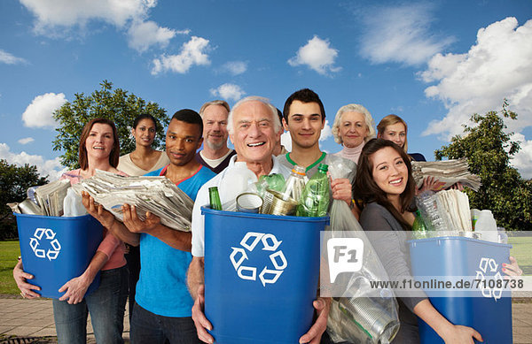 Group of people with recycling in bins
