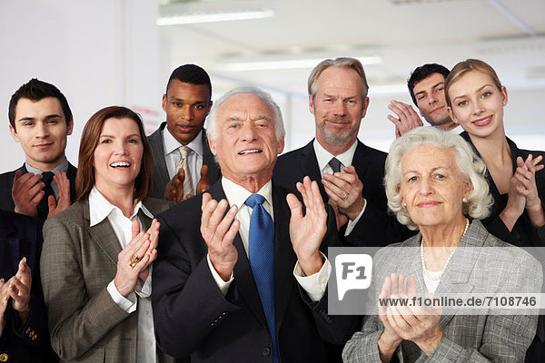 Businesspeople clapping