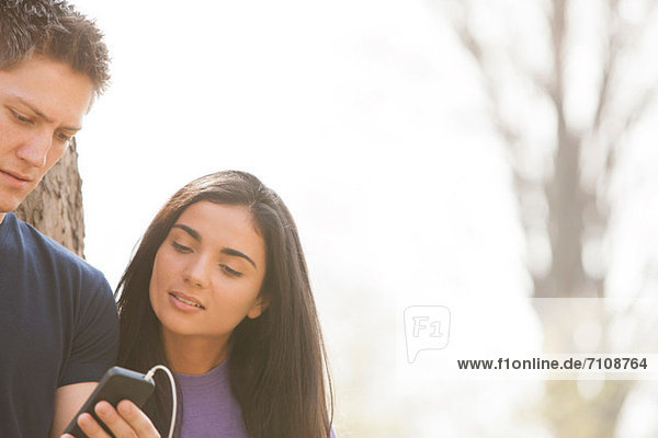 Young man and young woman with smartphone