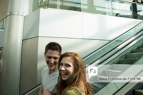 Young couple travelling on escalator