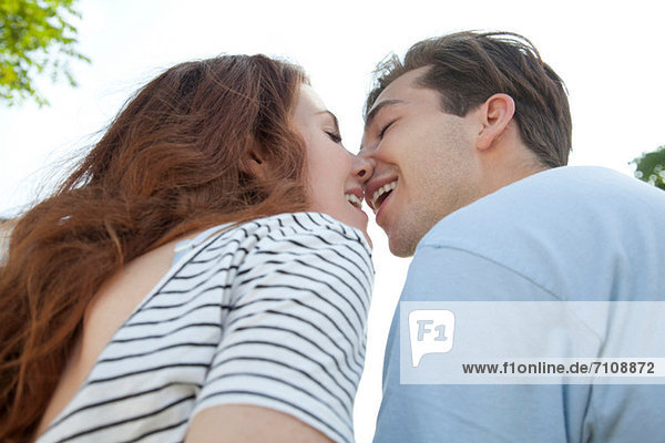Young couple kissing  low angle