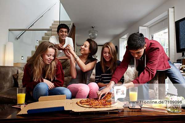Teenagers having take away pizza