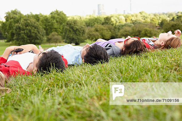 Teenagers lying in a park