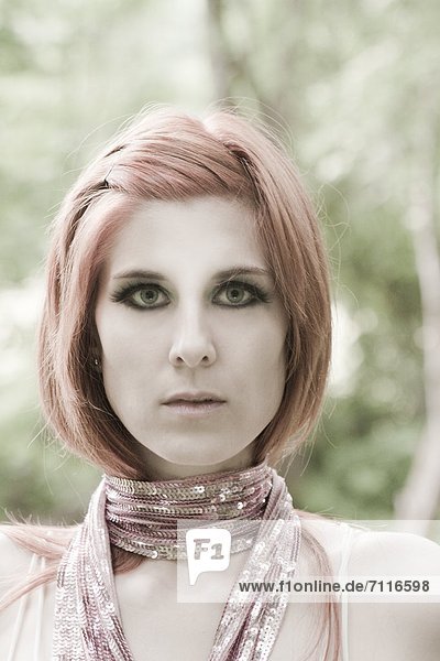 Red-haired young woman wearing scarf  portrait