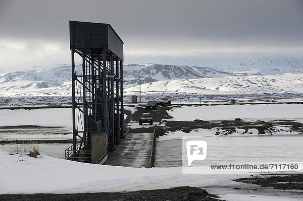 Super Jeeps approaching a bridge  _jÛrs· River  winter landscape  Icelandic Highlands  Iceland  Europe