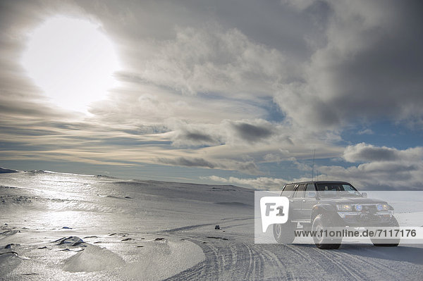 Super Jeep in a winter landscape  tyre tracks  Vatnajoekull Glacier  Icelandic Highlands  Iceland  Europe